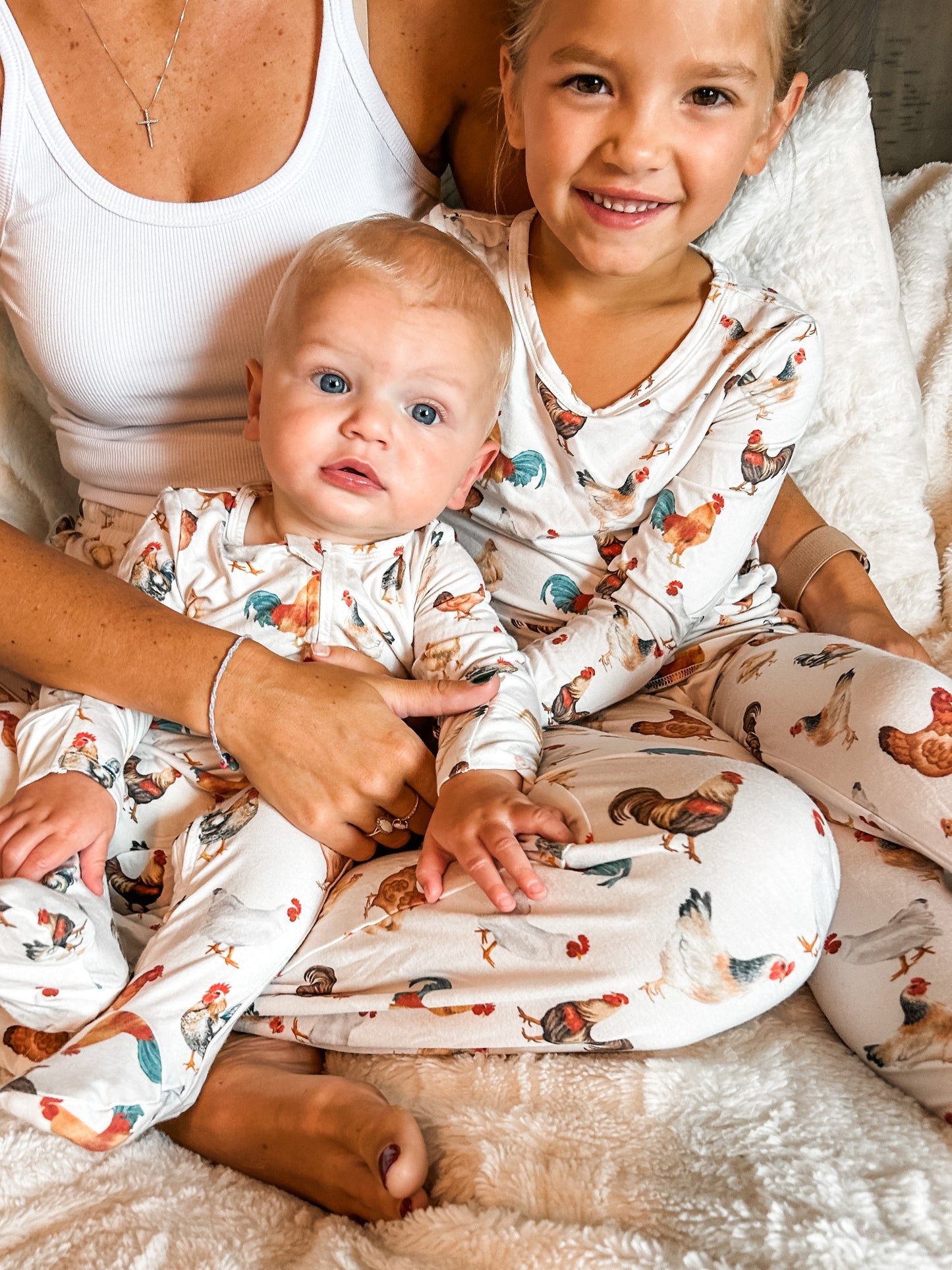 Mother and toddler photographed wearing a set of chicken pajamas