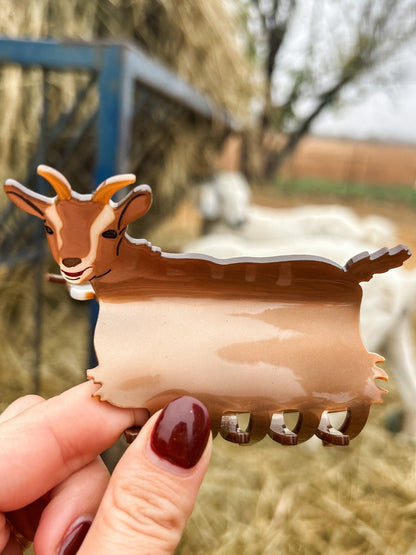 A woman showcasing the design of a Goat Claw Clip while holding it